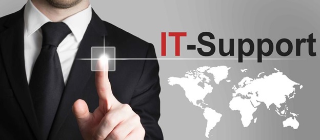 A partail image of a man in a black tie and sports jacket pressing against the screen with his index finger. Next to him is a white world map and the words IT Support